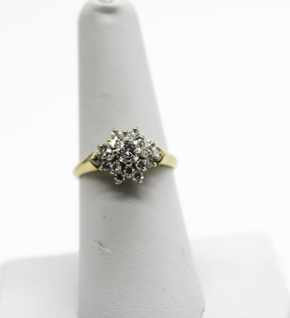 14K YG Diamond Snowflake Ring A:$3,000: One lady's 14kt. yellow and white gold cluster style ring. Weight: 3.3g, Size: 6.5 containing: Stone1Stone2 QUANTITY:1 Natural Diamond18 Natural Diamond SHAPE:Round Brilliant CutSingle Cut WEIGHT:0.28