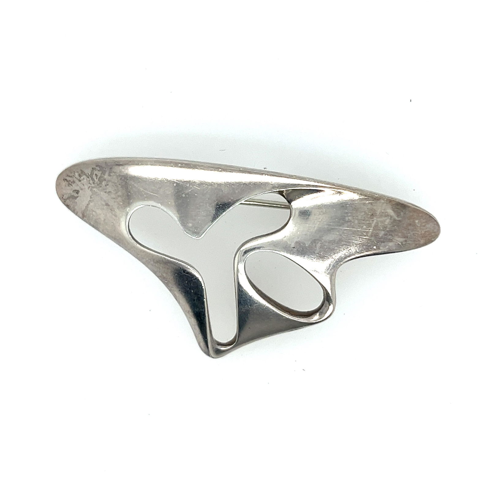George Jensen Abstract Brooch: Georg Jensen was a danish silversmith and designer, he achieved international prominence for his commercial application of modern metal design. This abstract piece is crafted of sterling silver and st