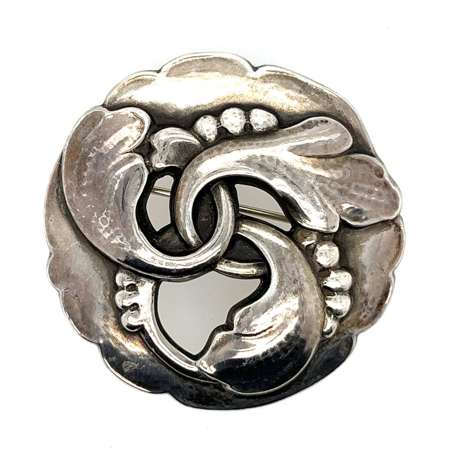 George Jensen Foliate Wreath Brooch: Georg Jensen was a danish silversmith and designer, he achieved international prominence for his commercial application of modern metal design. This beautiful foliate wreath brooch is a sought after p