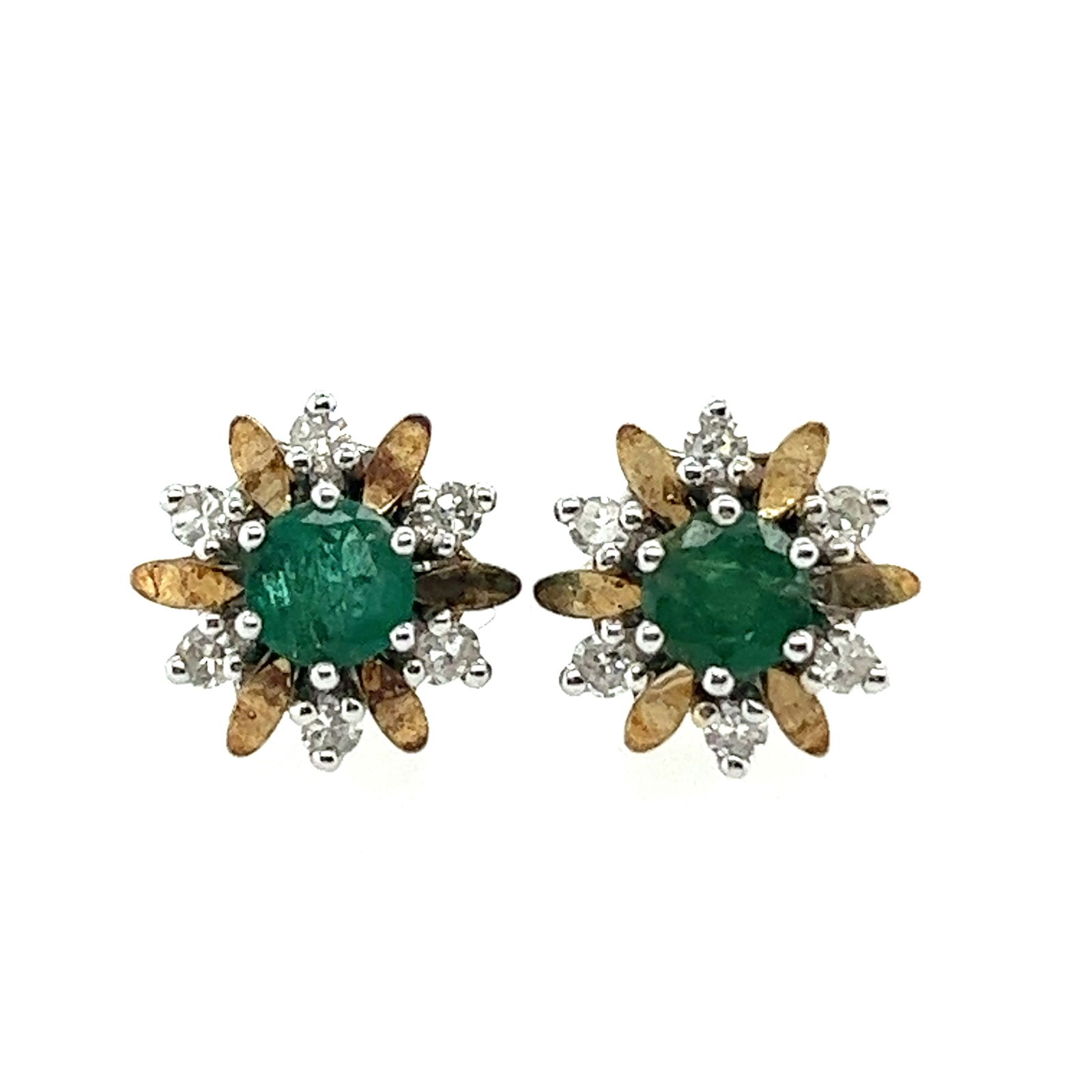Emerald & Diamond Earrings: Classic mixed with vintage. These studs are yellow and white gold flowers, each stud has 6 round diamonds and six yellow gold petals. Nestled in the center is a deep green round emerald. This earrings
