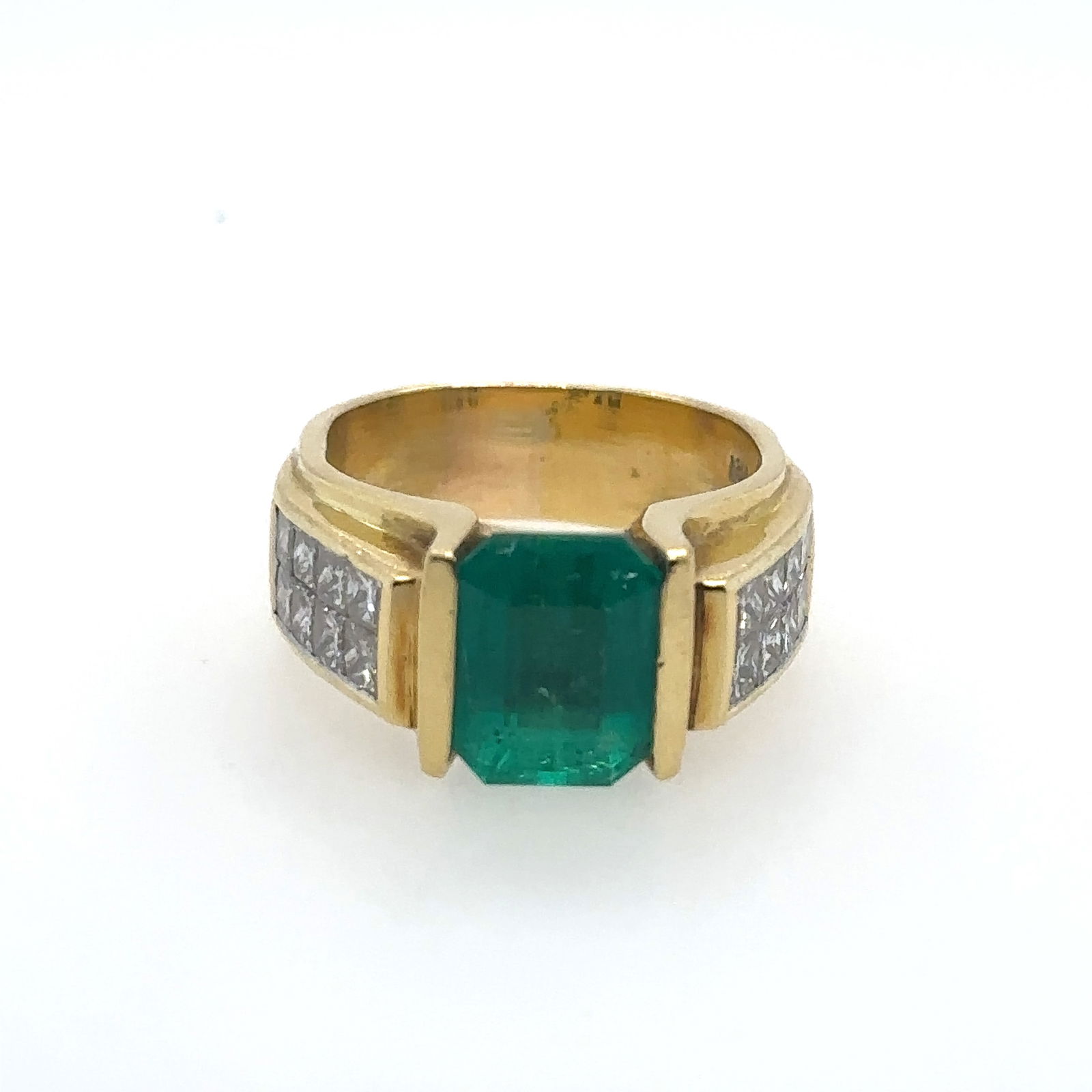GS Certified 18k Yellow Gold & Rhodium Enhanced Emerald Ring: Gemscan certified 1358574. One lady's custom made 18kt. yellow gold and rhodium enhanced channel and invisibly set ring containing one emerald cut natural emerald gauging 10.20 x 7.70 x 5.50mm, approx