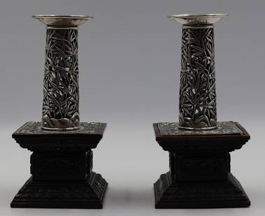 Pair of Chinese Export Silver Candlesticks by Wang Hing & Co: These finely detailed Qing Dynasty candle sticks feature reticulated bamboo designed cylindrical bodies radiating from a rocky landscape. A similar motif done in repousse decorates the square shaped b