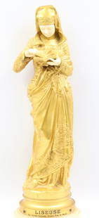 Albert-Ernest Carrier-Belleuse, French (1824-1887): Omolu / doré bronze & ivory figural study showing a finely detailed standing woman with downward gaze. The whole is mounted to a turned onyx plinth. Titled: ‘’La Liseuse’’ (The Reader) artist