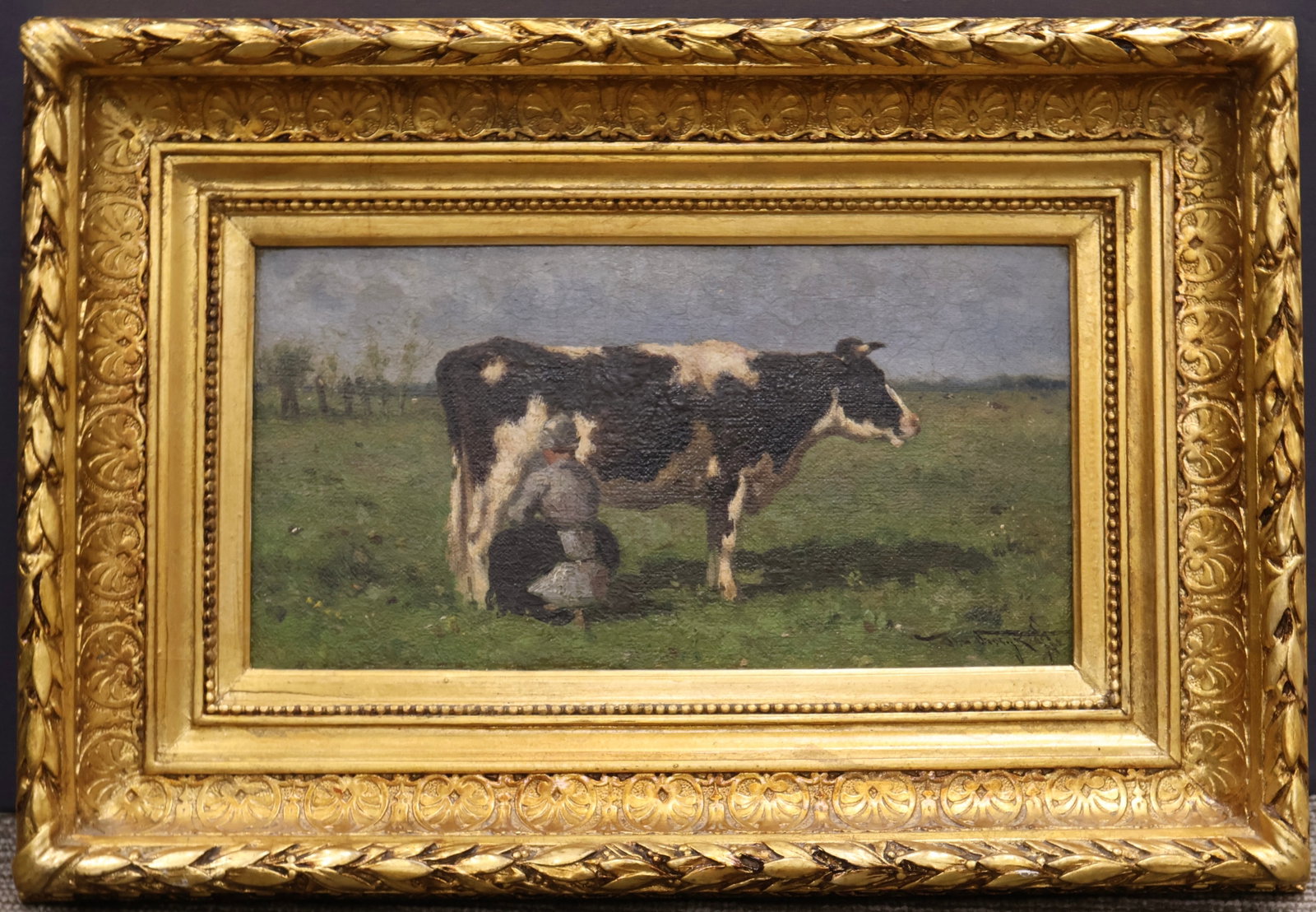 Johannes Martinus Vrolijk, Dutch (1845–1894): Oil on board showing a maiden milking a cow. Gallery label verso. Signed l/r, Image size: 6’’x11.5’’ (Frame size: 17.5’’x12’’).