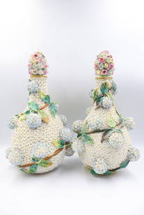Rare pair of 19th century German Meissen ‘’Schneeballen’’ vases: This hand painted collectors piece features rosette encrusted bottle shape covered vases bearing serrated leaf filled vines highlighted by Schneeballen (snowballs). Underglazed crossed sword mark to t