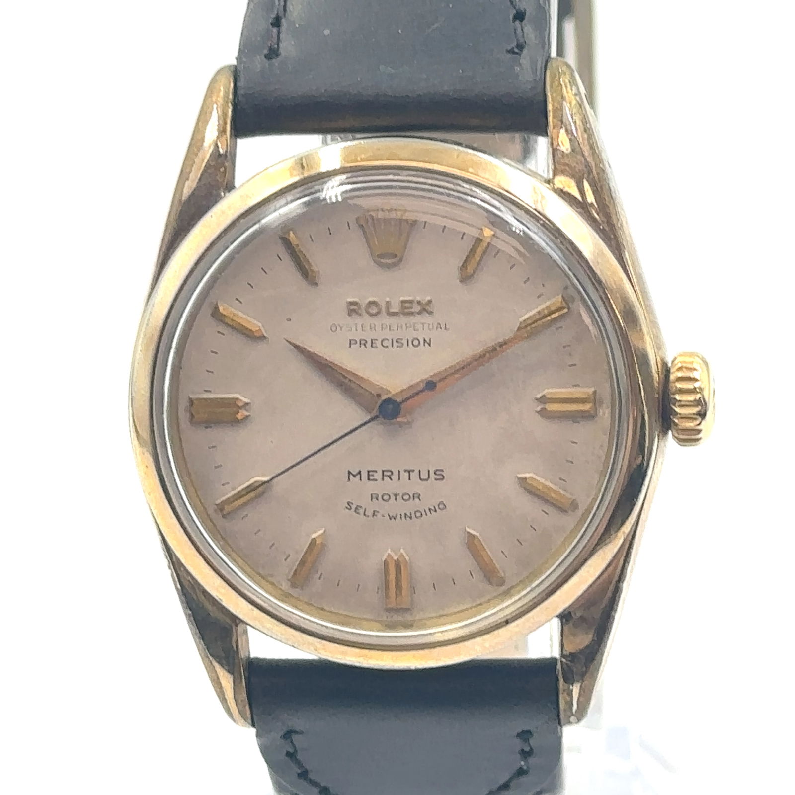 1950's Rolex Meritus 6594 Automatic Men's Watch: The 1950's Rolex Oyster 6594 Automatic Men's Watch is a vintage luxury timepiece with a classic design. Crafted in yellow gold, this Swiss-made watch features a champagne dial with a 12-hour display a