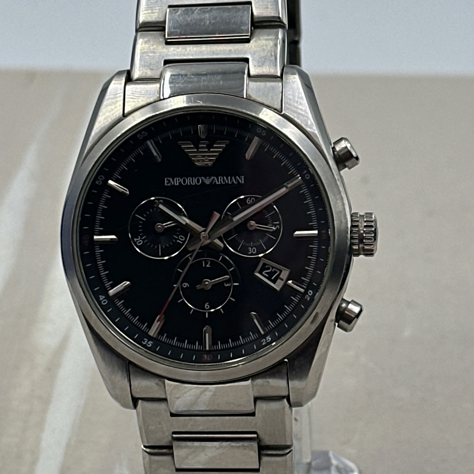 Emporio Armani Sportivo Quartz Men's Watch: Crafted for the modern man, the Emporio Armani Sportivo Men's Watch seamlessly blends style with functionality. The sleek stainless steel case, complemented by a matching bracelet and bezel, frames a