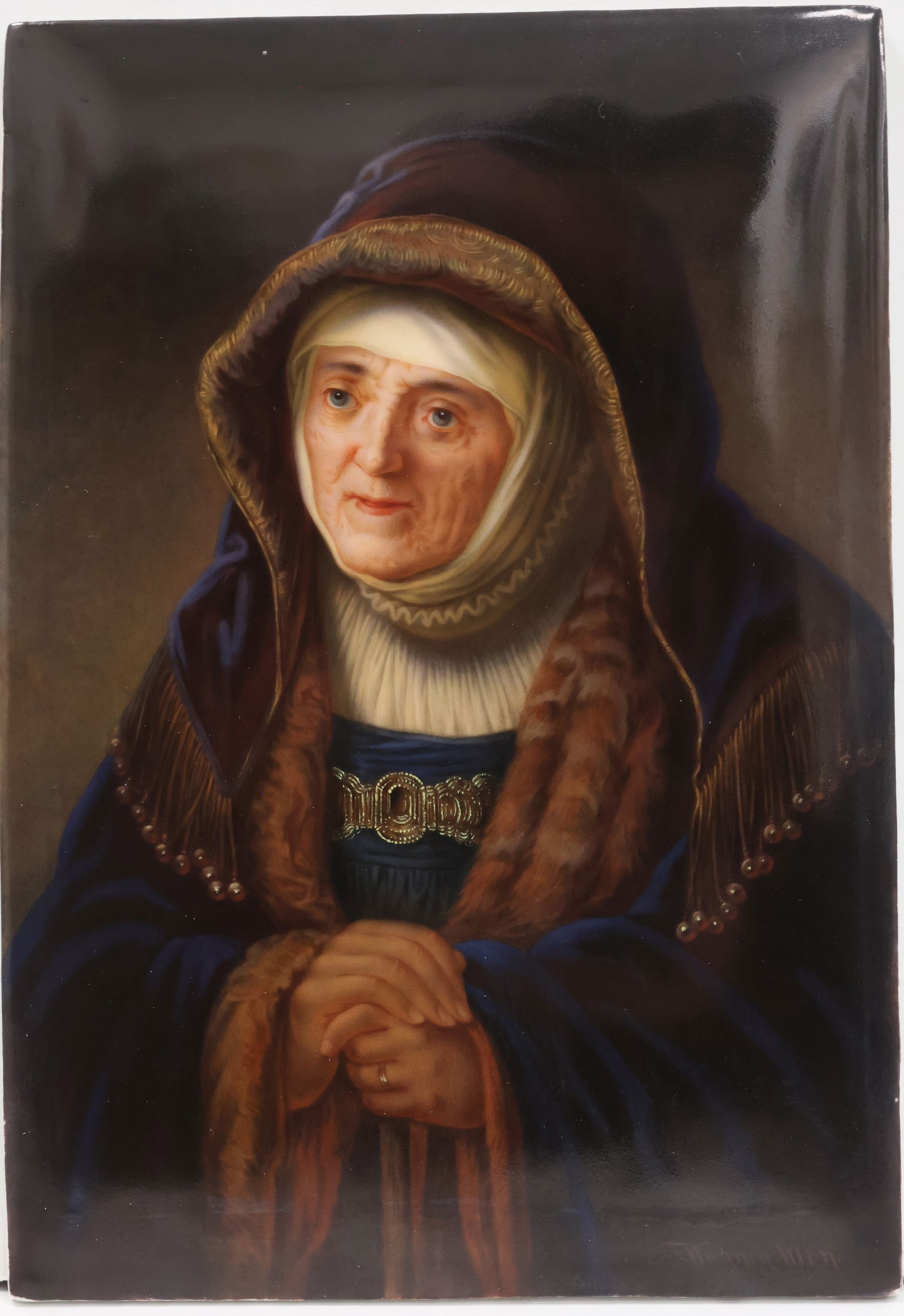 An antique KPM/Royal Vienna porcelain plaque – signed Wagner: This finely executed hand painted portrait plaque is titled: “Rembrand’s Mutter(Rembrandt’s Mother)”. The original painting by Rembrandt circa 1639 is on permanent display in the Kunsthist