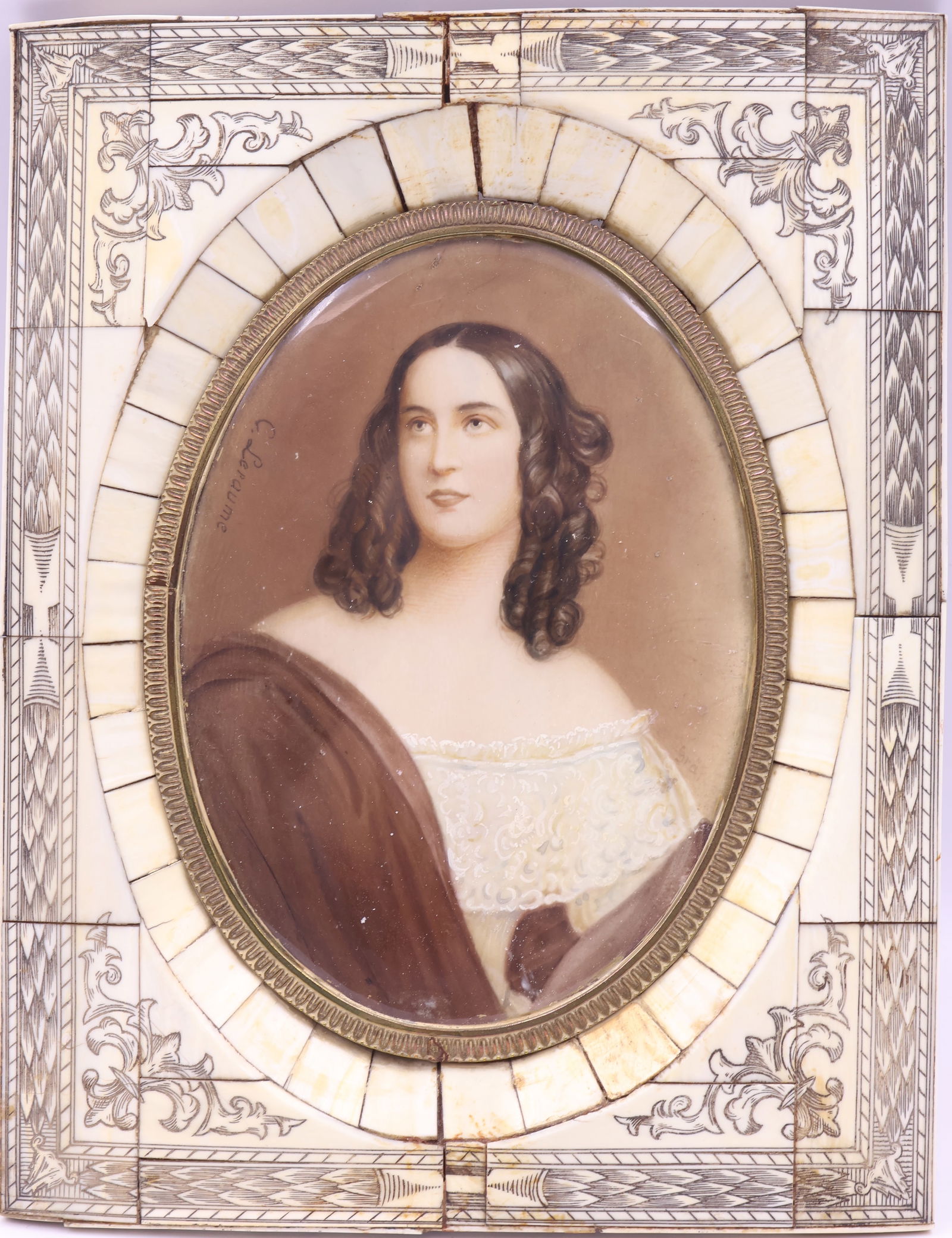 C Leraume, European School: Miniature portrait of a beautiful young girl with bare shoulders and lace gown. The whole is mounted to a bone frame with fine incised carving, condition noted. Signged m/l, Image size: 5.5"x4.25" ova