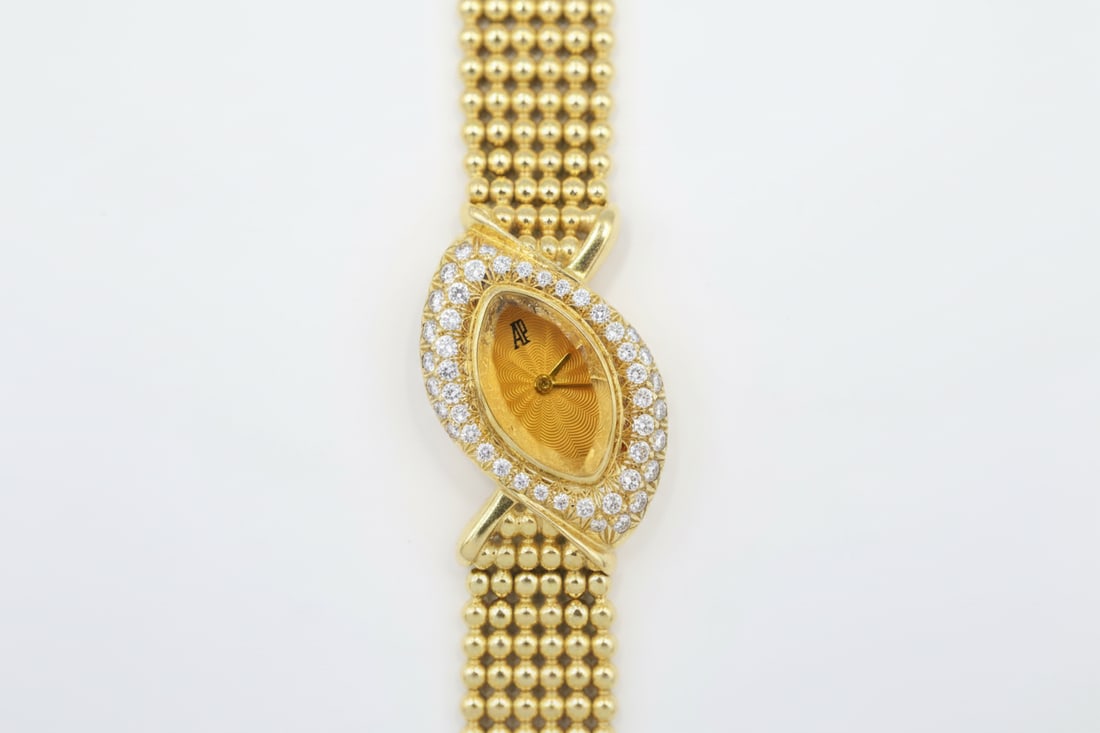 Audemars Piguet 18k Ladies Watch — Ref C41697: Audemars Piguet ladies' watch, reference C41697. 18k yellow gold case, 26 × 18mm. Pavé diamond bezel. Marquise-shaped crystal dial. Quartz movement. Total weight: 51g. Presented with original box