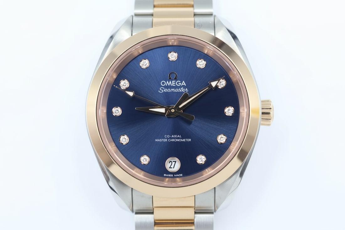 Omega Seamaster Aqua Terra — Diamond Dial: Omega Seamaster Aqua Terra 150m Co-Axial Master Chronometer. 34mm two-tone stainless steel and rose gold case. Blue sunbrushed dial with diamond hour markers. Automatic movement. Matching two-tone