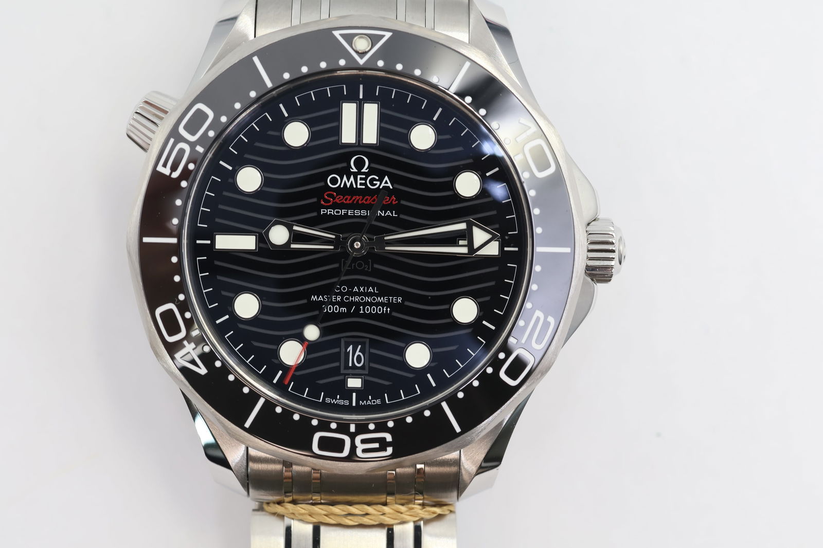 New Omega Seamaster Automatic — Unworn, Box & Papers: Omega Seamaster automatic watch in new, unworn condition. Protective sticker still in place. Black wave dial. Case size: 42 mm. Presented with original box and papers.