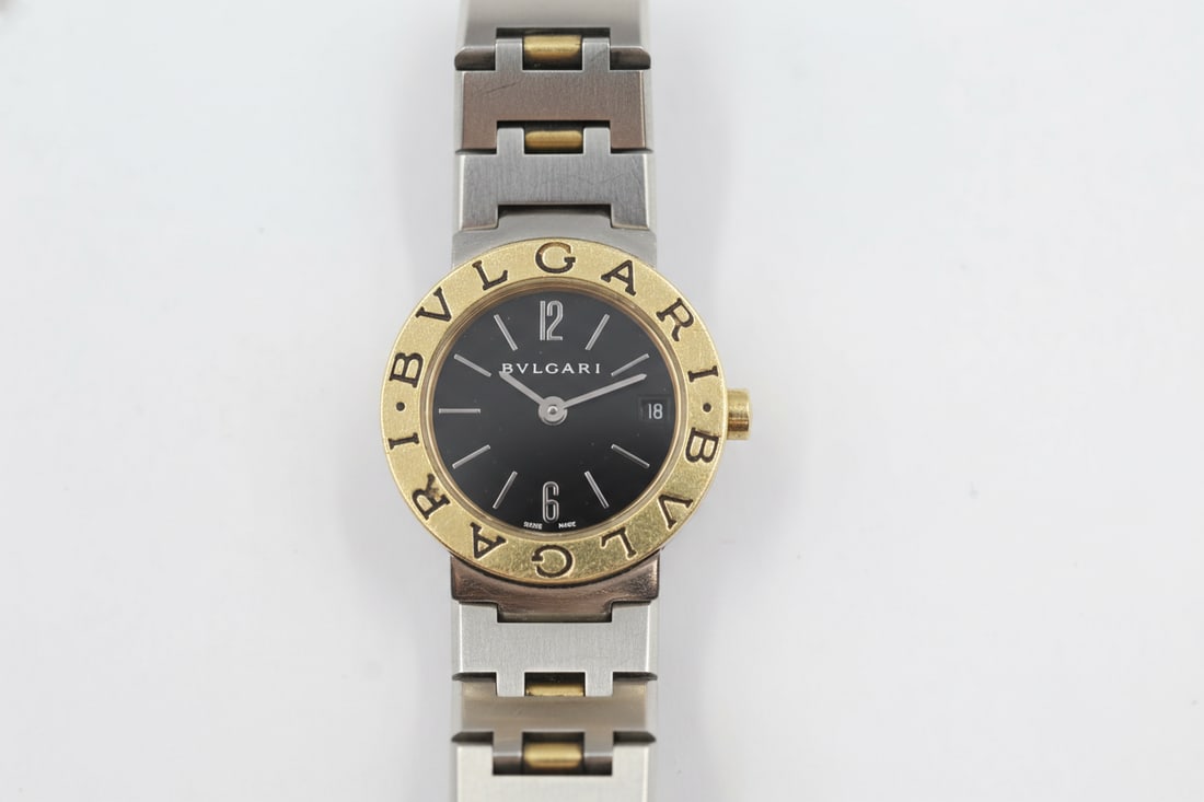 Bulgari Two-Tone 18k Gold & Steel Ladies Watch: Bulgari ladies' quartz watch. 22mm case in stainless steel and 18k yellow gold with two-tone bracelet. Black dial with Arabic numeral and stick markers. Swiss-made. Fits wrist up to 5.75–6 inches.