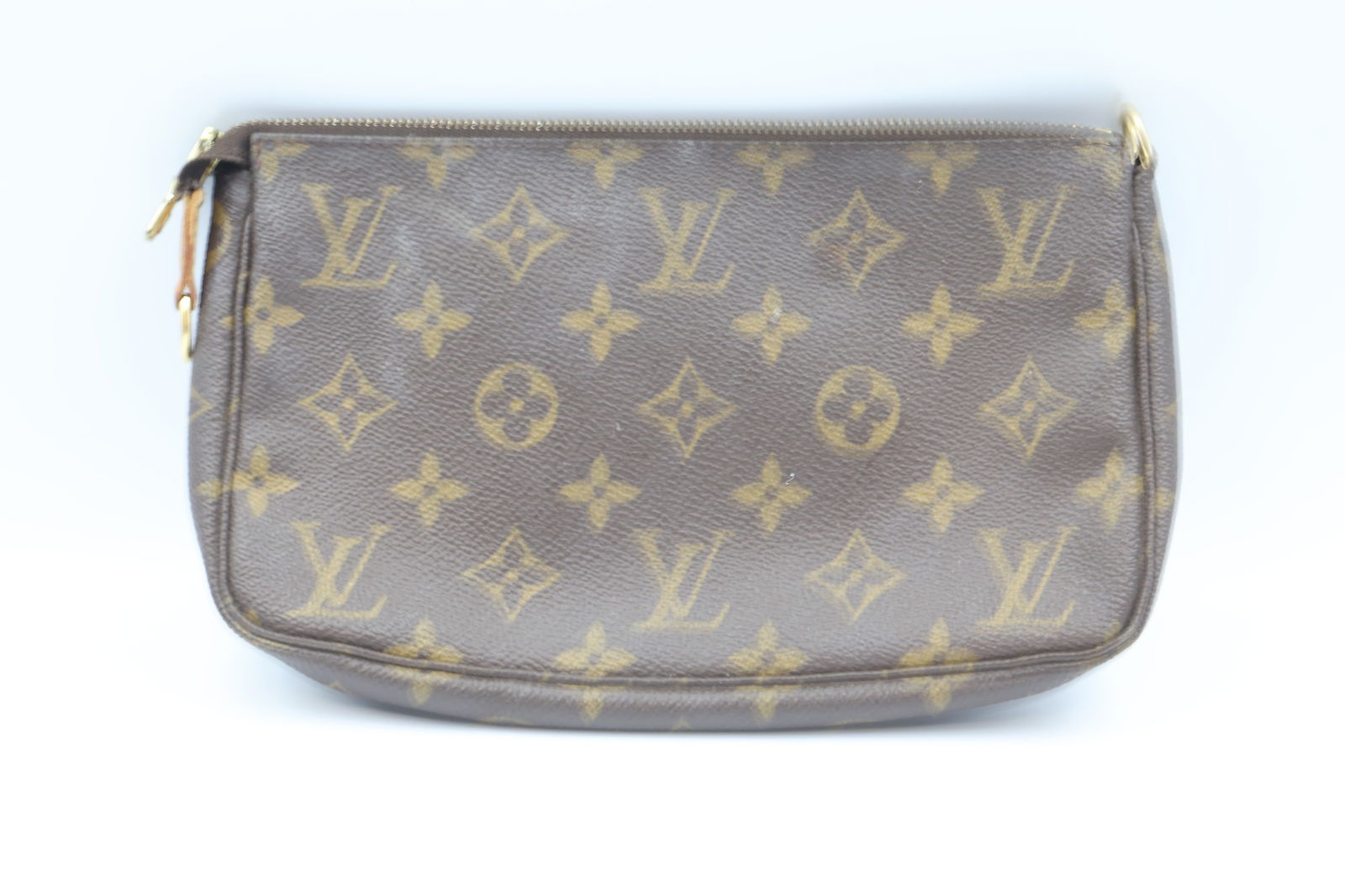 Louis Vuitton Small Cosmetic Pouch: Louis Vuitton small cosmetic pouch in monogram coated canvas. Dimensions: 8.5" L × 5" H × 1.5" W. Exterior in good condition; visible wear — refer to photographs.