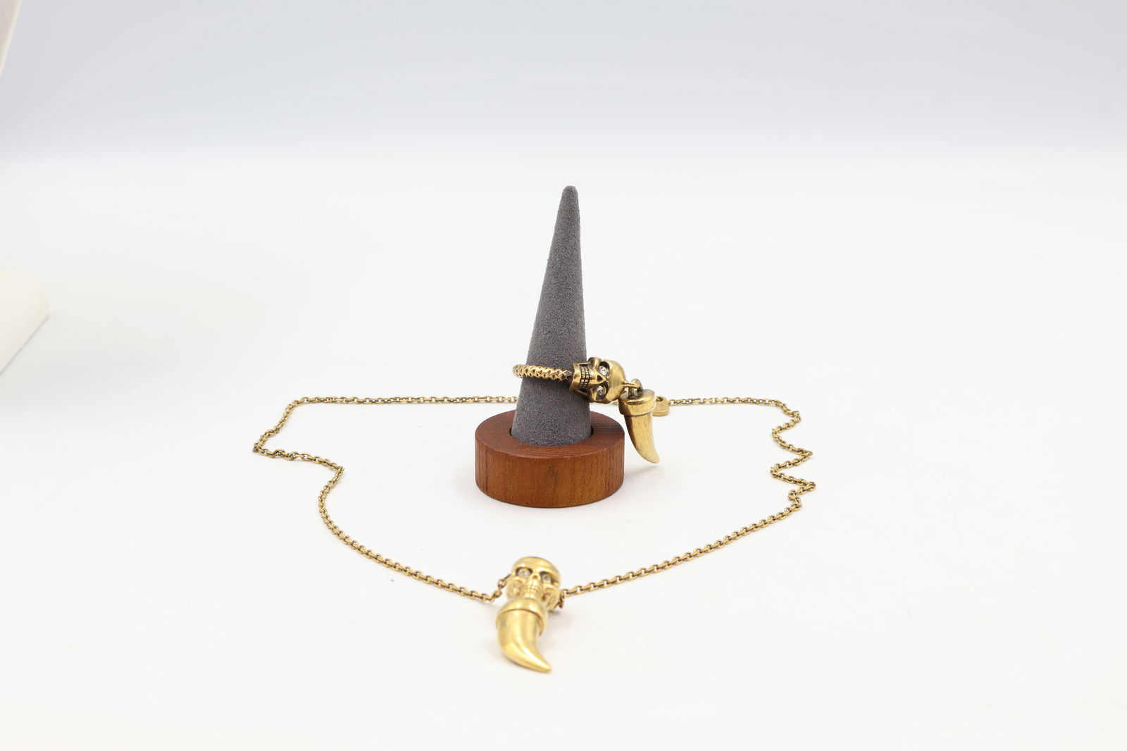 Alexander McQueen Skull Pendant & Ring Set: Alexander McQueen gold-tone skull pendant and matching ring, each set with 2 natural diamonds (confirmed). Pendant on 20-inch oval link chain with lobster clasp. Ring size 6.5. Signed Alexander