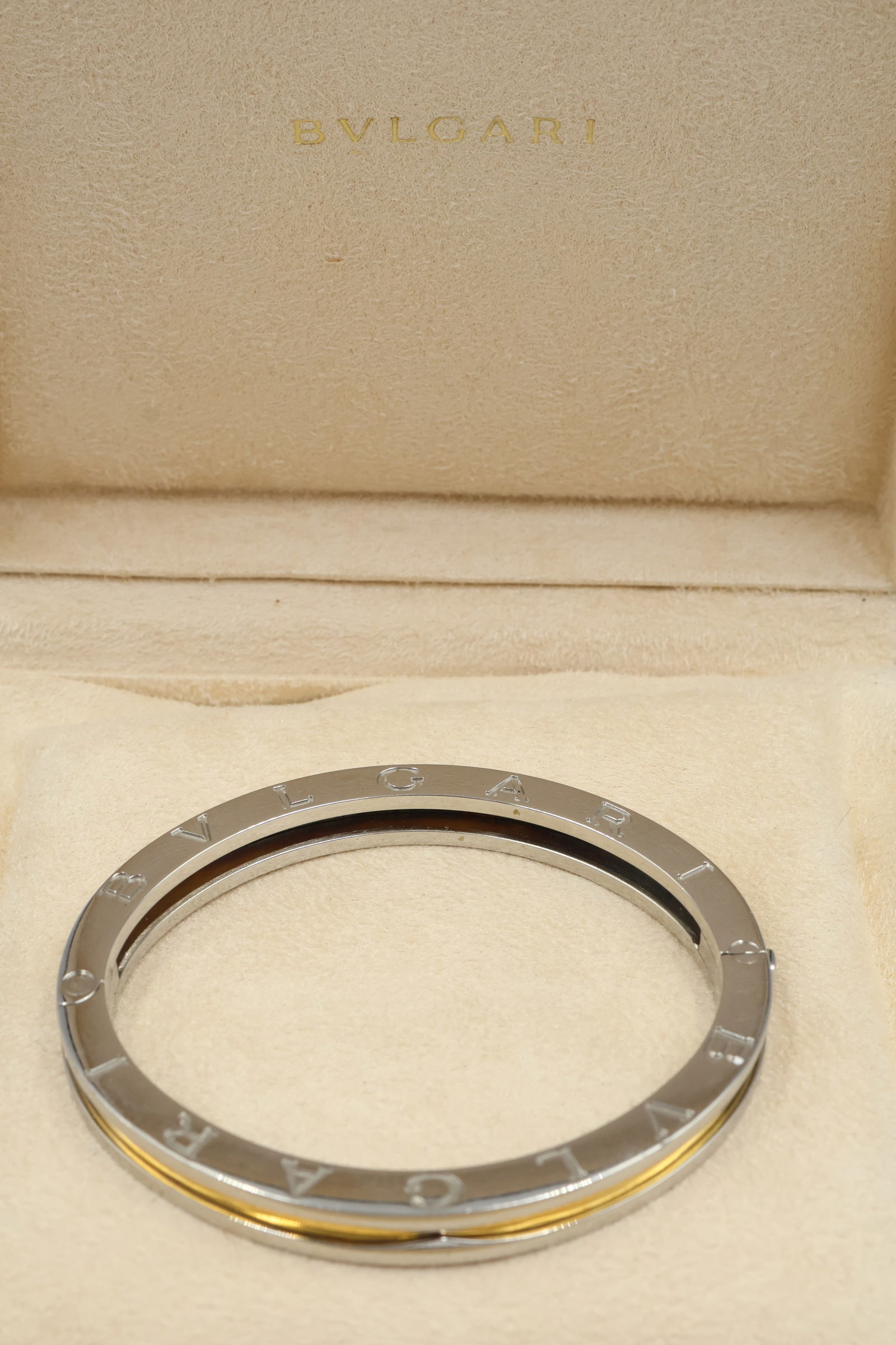 Bulgari B.Zero1 18k Gold & Steel Bangle — Box: Bulgari B.Zero1 bangle bracelet in 18k yellow gold and stainless steel. Fits 6.5-inch wrist. Total weight: 28.3g. Presented with original Bulgari box. Stamped Bulgari, 750.