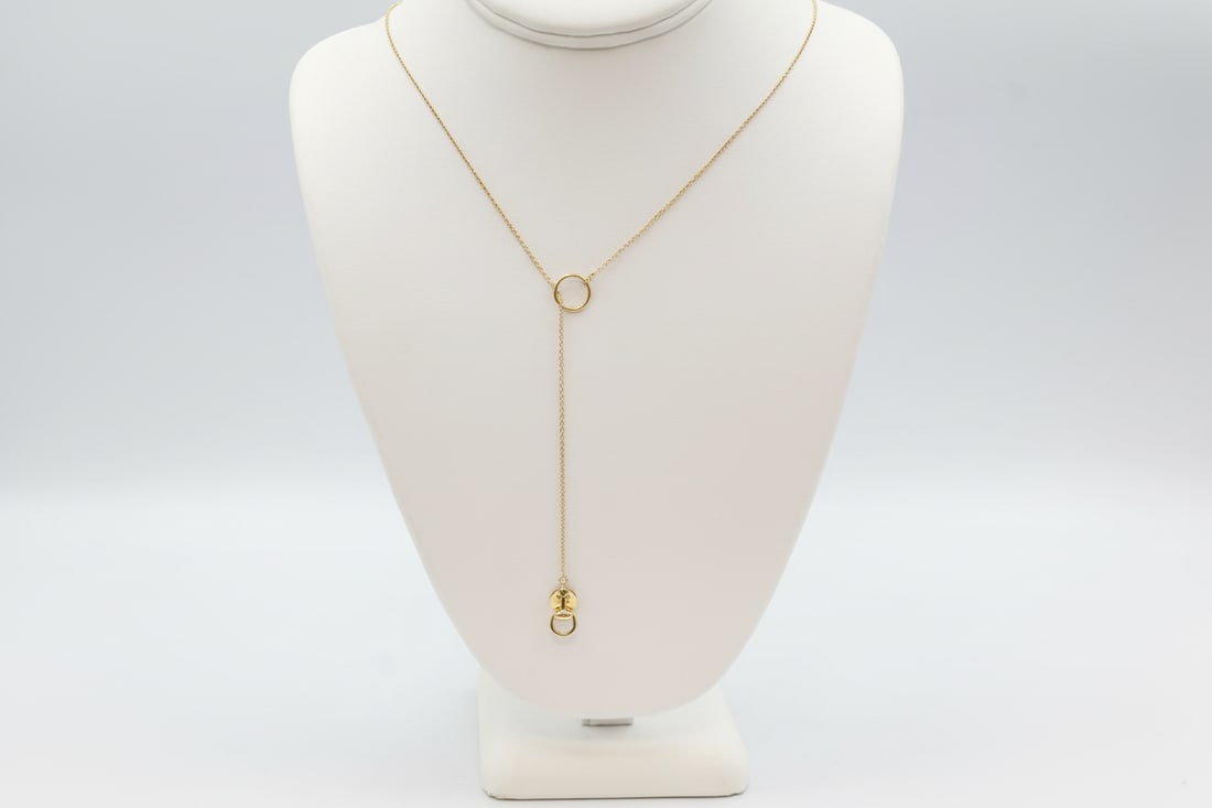 Gucci 18k Gold Lariat Necklace: Gucci lariat necklace in 18k gold. Total weight: 4g. Stamped Gucci, 750.