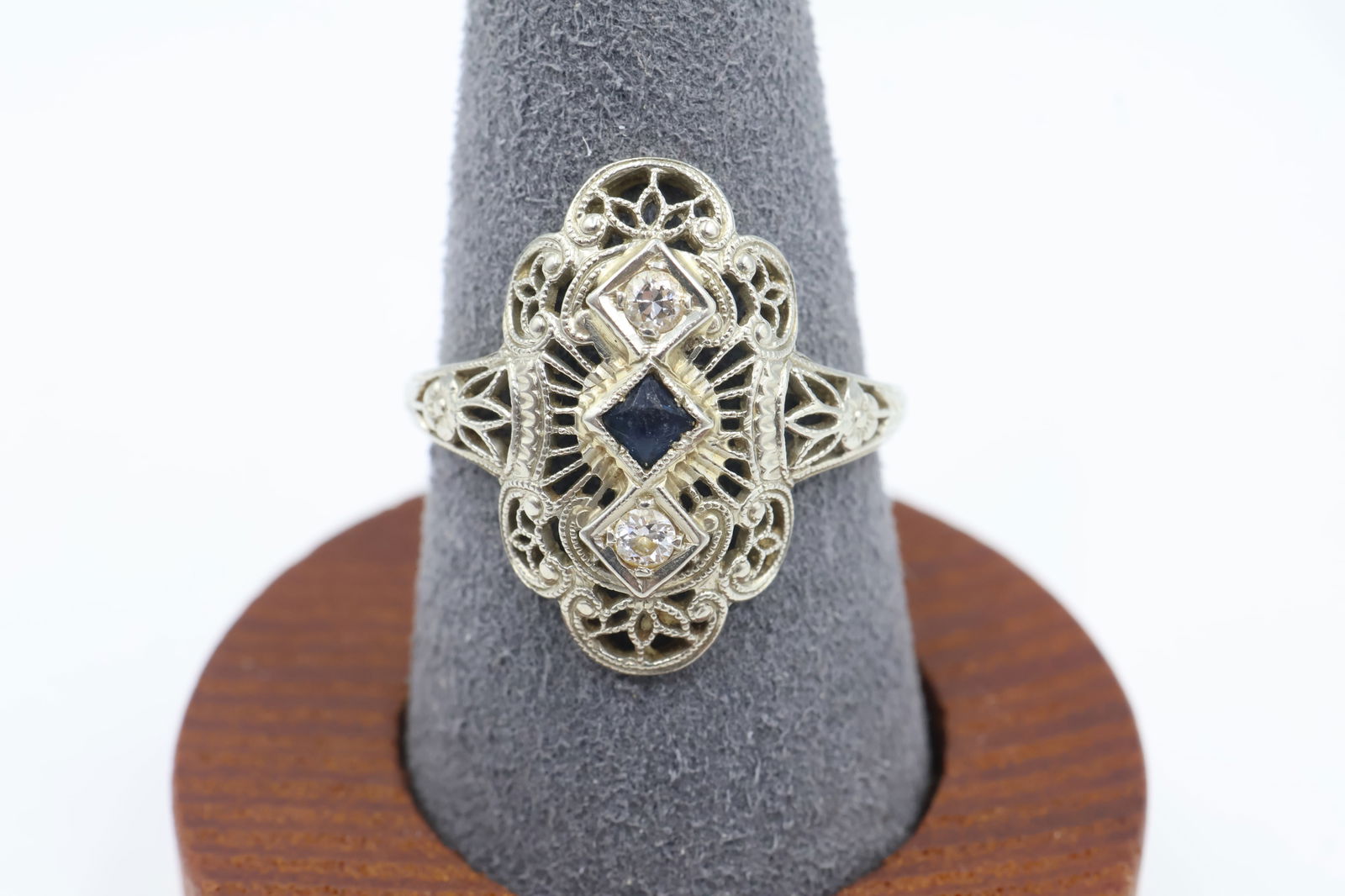 Art Deco–Inspired 18k White Gold Sapphire & Diamond Ring: This elegant Art Deco–inspired ring features rich, deep-blue sapphires accented by sparkling diamonds, all set in polished 18k white gold. Weighing 3 grams, it offers a refined, timeless look with