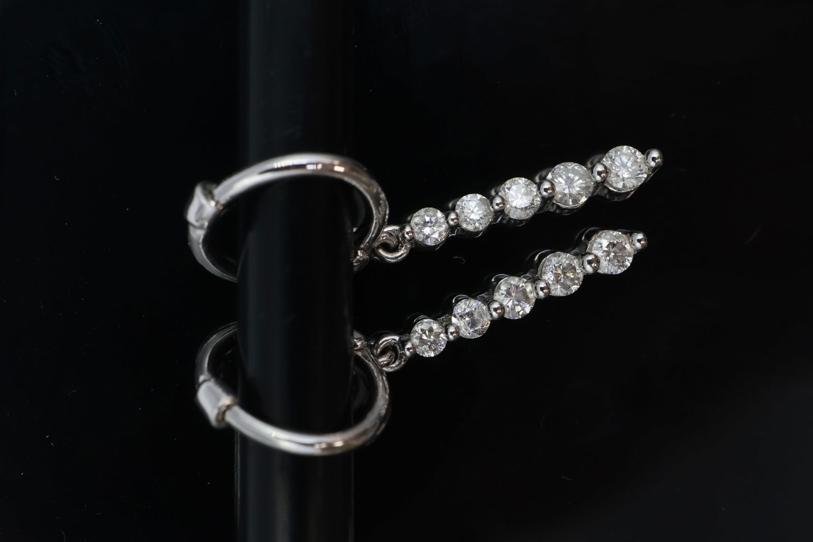 14K White Gold Petite Diamond Dangle Earrings: 14K White Gold & Diamond Dangle Earrings featuring a total weight of 2 grams. Each earring is set with five petite, sparkling diamonds that catch the light beautifully as they sway. Elegant and lightw