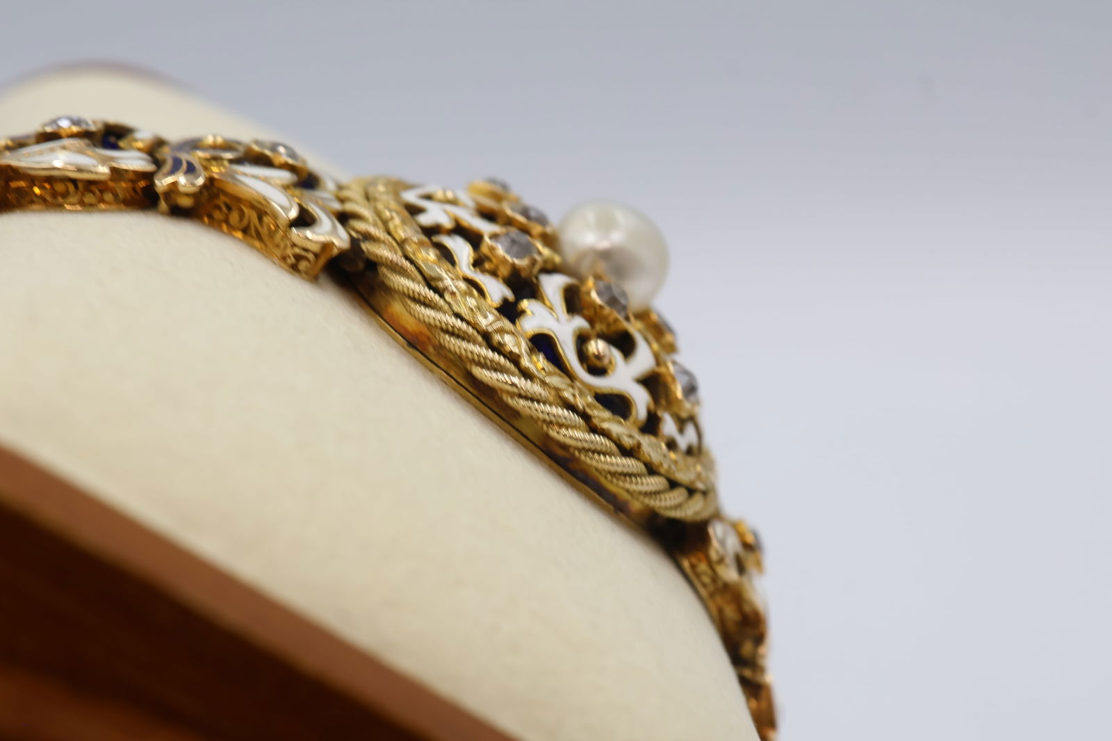 Handmade Antique 14K Gold Bracelet w/ Old Mine Cut Diamonds, Pearl & Enamel – Appraisal Included: Lady's 14k yellow gold hadmade antique diamond , pearl and enamel bracelet, hinged link with scroll design inlaid with blue and white enamel and recessed basket settings. Containing: twenty old mine c
