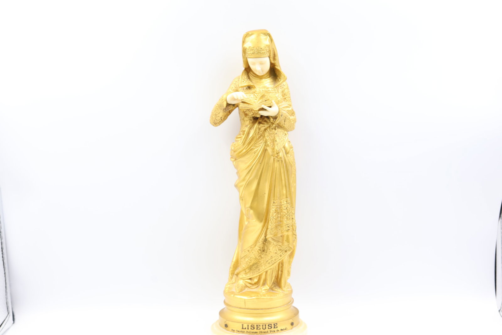 Albert-Ernest Carrier-Belleuse, French (1824-1887): "Ormolu / dore bronze figural study showing a finely detailed standing woman with downward gaze. The whole is mounted to a turned onyx plinth. Titled: La Liseuse (The Reader) artist signature inscribe
