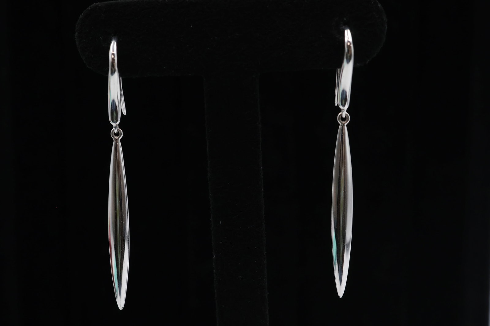 Tiffany & Co 18K White Gold Earrings: Tiffany & Co. earrings crafted in polished 18K white gold, featuring a sleek, contemporary design. Total weight approximately 6.3 grams. Signed Tiffany & Co.