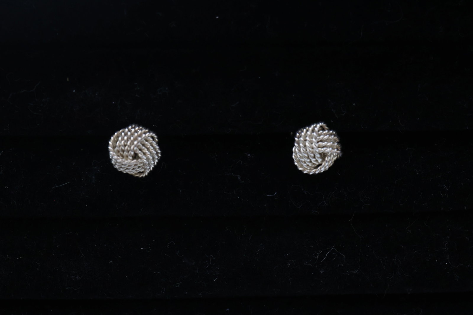 Tiffany & Co 925 Twist Knot Studs: Classic Tiffany & Co. stud earrings crafted in sterling silver and featuring an elegant twist-knot design. A timeless and versatile pair showcasing the House’s signature understated sophistication. 