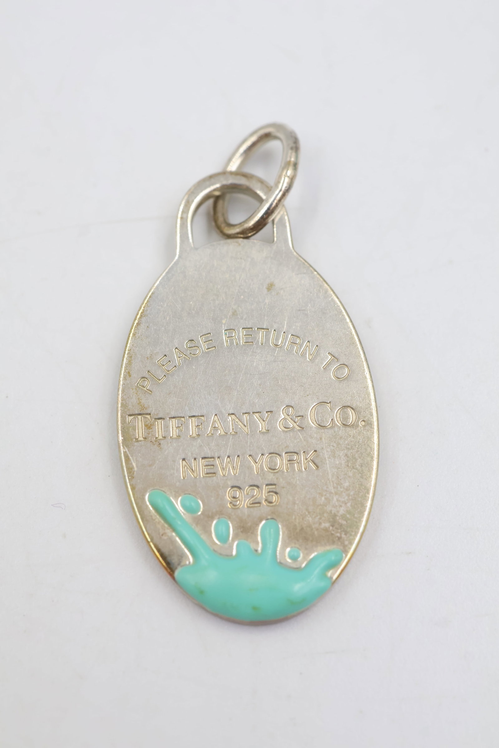 Tiffany & Co 925 Return To Tiffany Colour Splash Charm: Tiffany & Co. charm featuring turquoise enamel detailing. Total weight: 7.5 grams. Accompanied by a Tiffany & Co. pouch