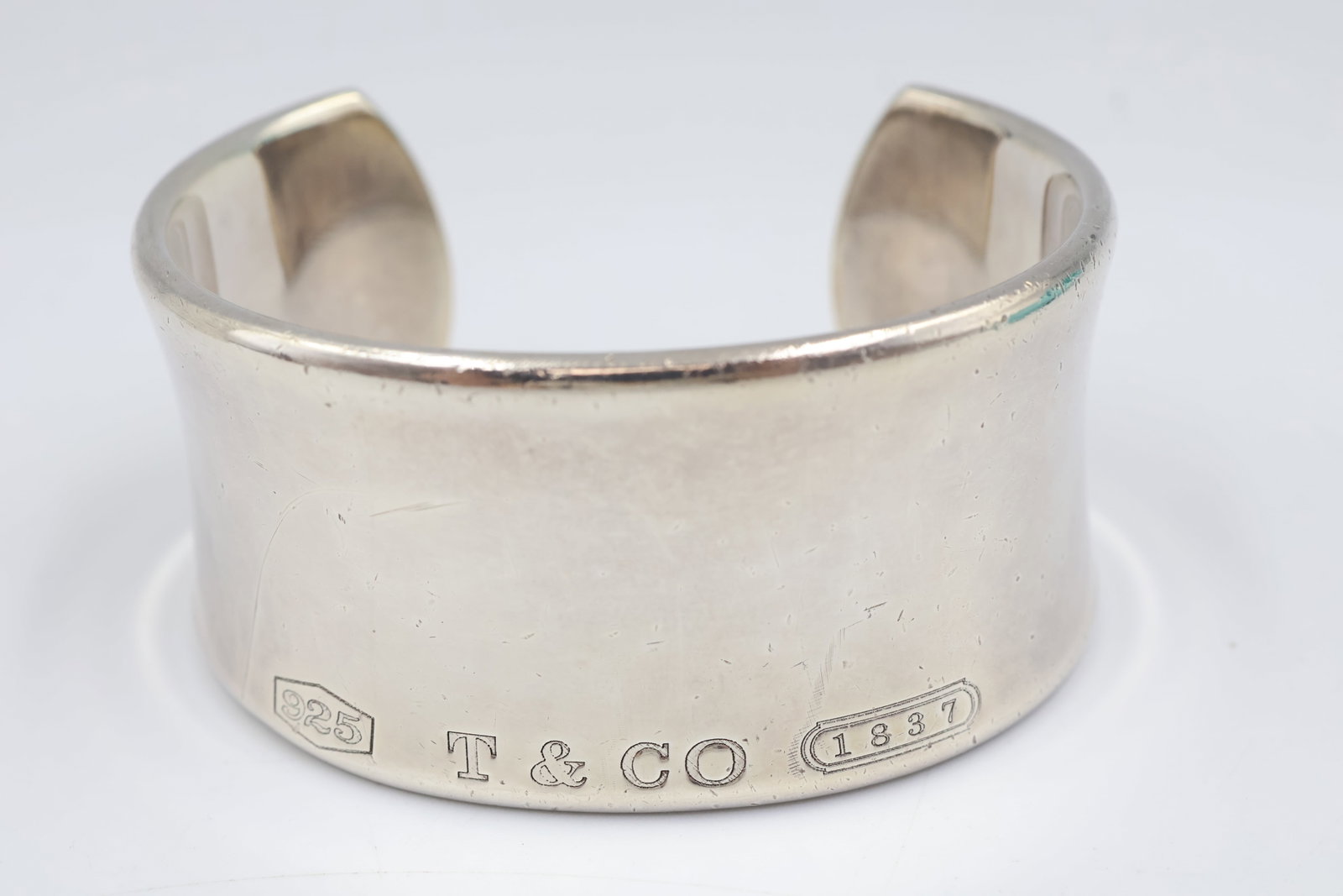 Tiffany & Co 1837 Sterling Silver Cuff: Tiffany & Co. 1837 cuff crafted in sterling silver. Measures approximately 6 inches. Total weight: 83.76 grams. Accompanied by a Tiffany & Co. pouch.