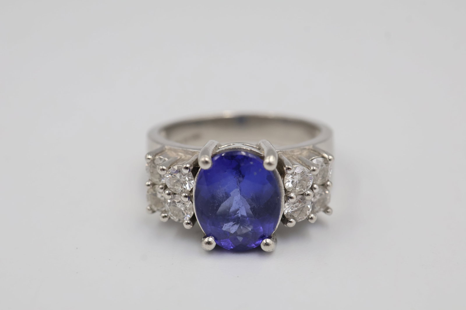 Platinum & 2.50 Tanzanite Ladies Ring: Platinum ladies’ ring featuring a 2.50 ct tanzanite accented by 8 diamonds totaling approximately 0.80 ct, graded I–J colour, I2–I3 clarity. Ring size: 7. Total weight: 11.68 grams. Appraisal