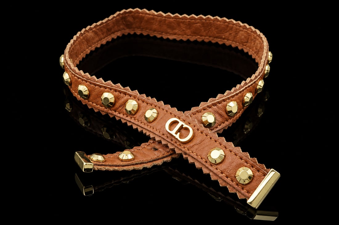 Dior Suede Studded choker: Distinctive Dior choker crafted in rich brown suede and accented with gold-tone studs. A bold statement piece showcasing the House’s sophisticated and contemporary style.