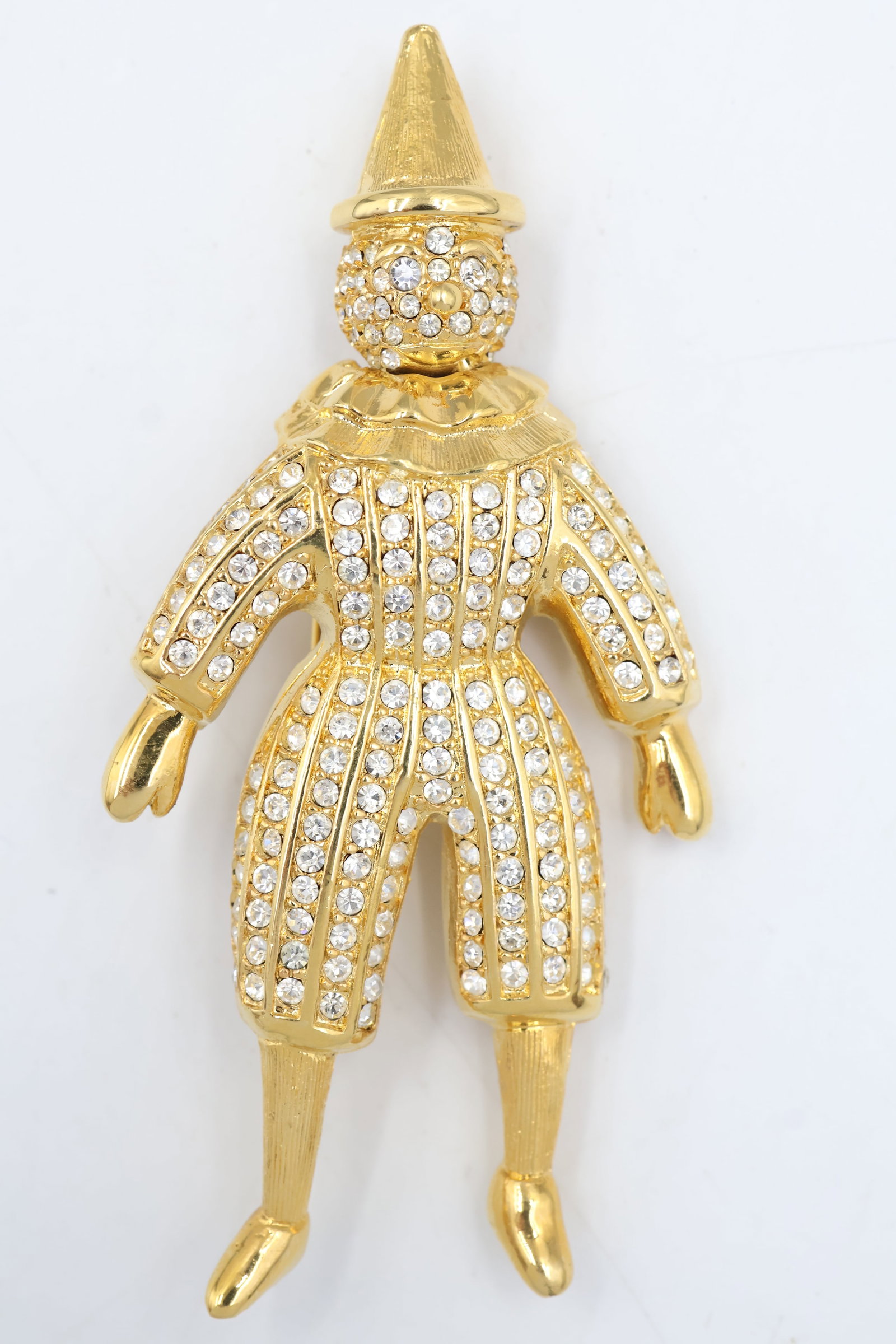 Dior Pierrot The Clown Brooch With Pave Crystals: Dior Pierrot clown brooch accented with sparkling pavé crystals. A whimsical and collectible statement piece showcasing the House’s imaginative Parisian design.