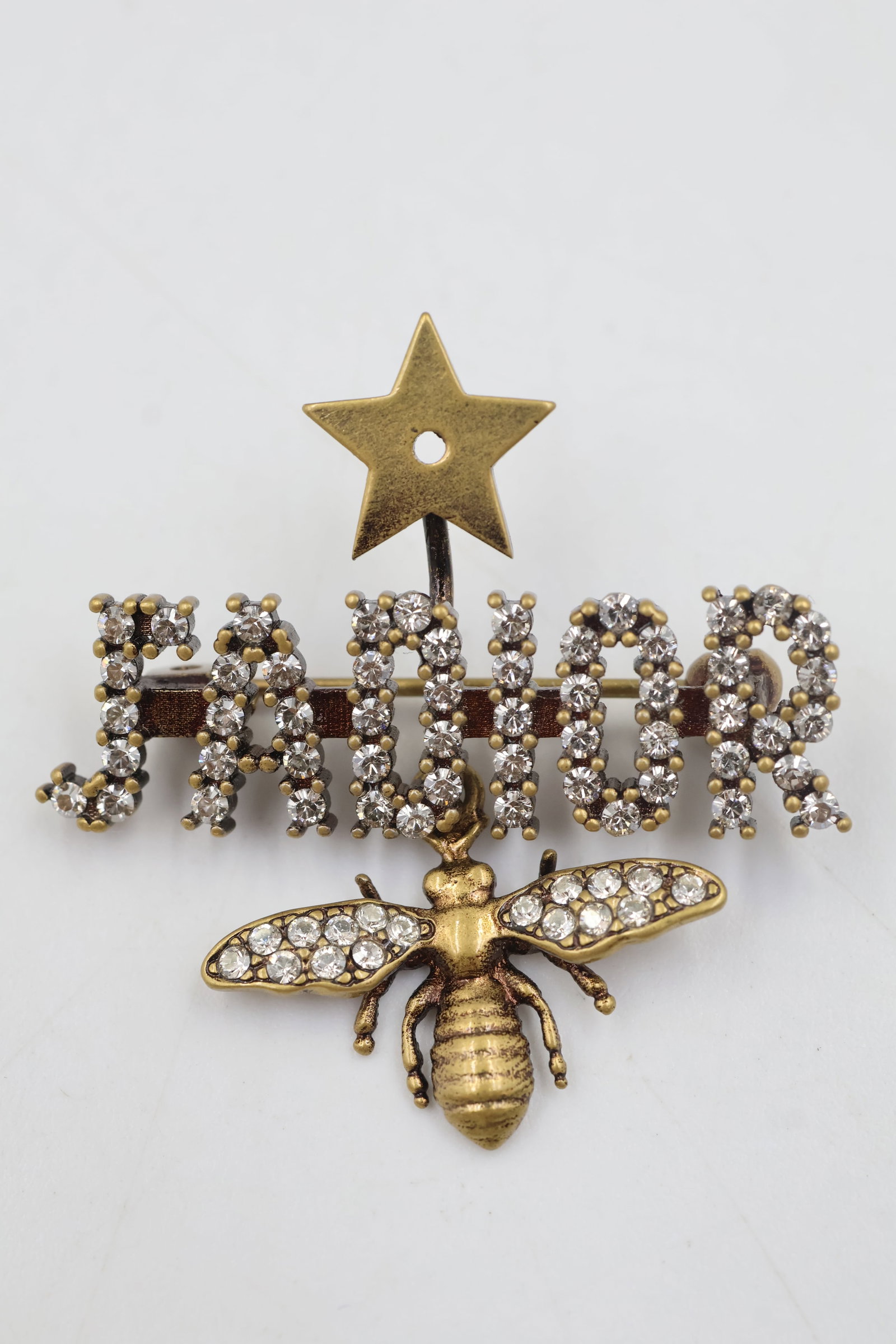 Dior J'ADIOR Crystal Bumblebee Pin: Dior J’ADIOR bumblebee pin featuring sparkling crystal embellishments in a polished gold-plated finish. A distinctive and collectible Dior accessory.