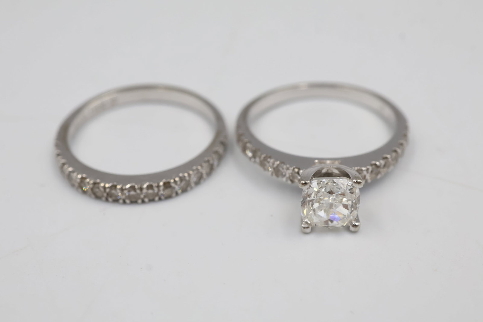 18k White Gold Engagement Set: Elegant 18K gold bridal set featuring a coordinated engagement ring set with a 1.51 ct cushion cut diamond and 14 round brilliant cut diamonds weighing 0.03 cts each. Centre diamond colour is G and