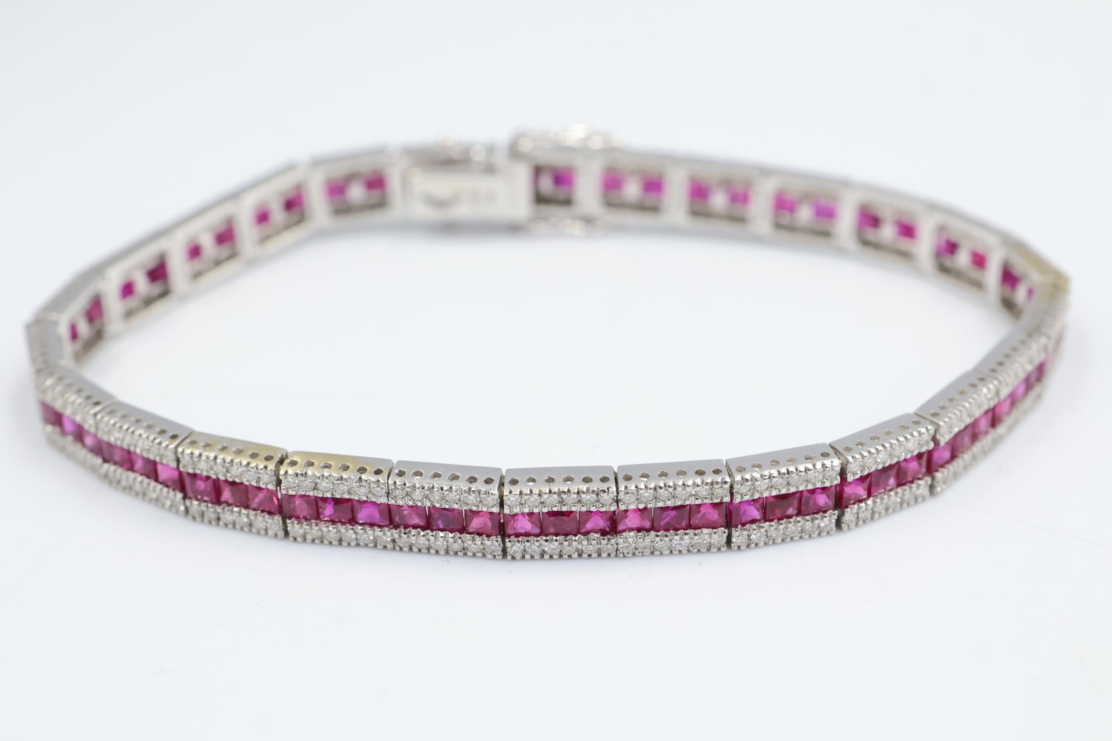 18k Diamond & Ruby Tennis Bracelet: 18K gold tennis bracelet set with sparkling diamonds and vibrant rubies. A timeless fine jewellery piece combining rich colour with exceptional brilliance. Fits a 7" wrist. Weight 18.47 grams.