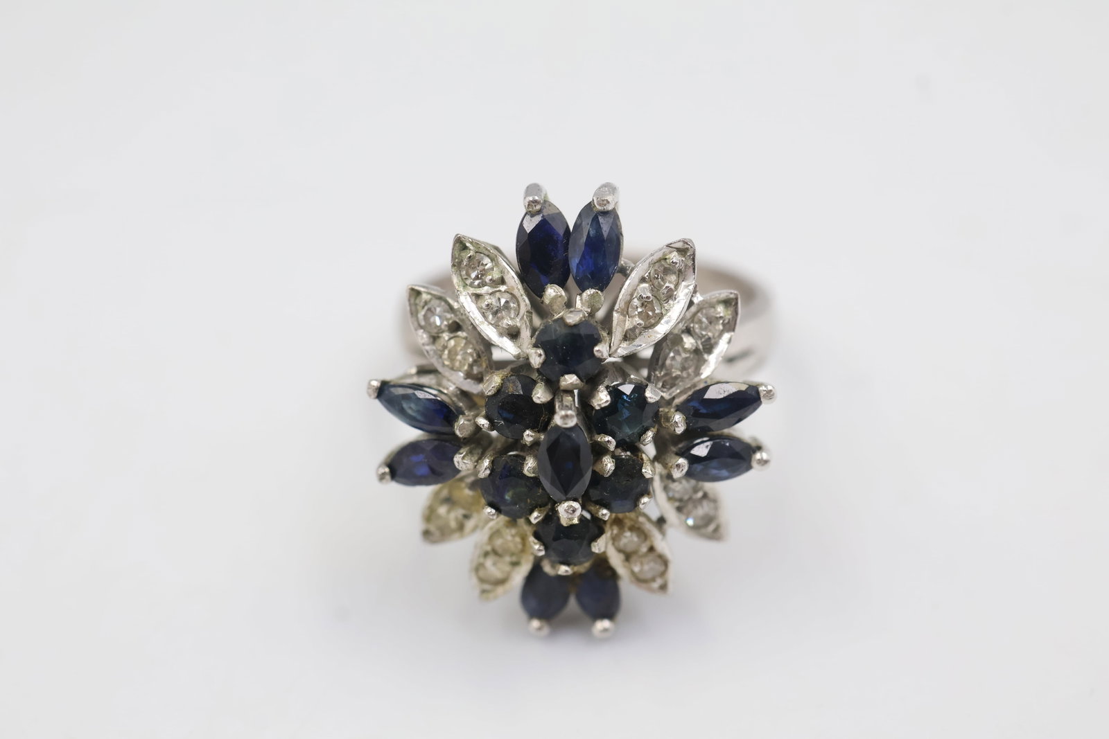 10k Sapphire & Diamond Ring: Elegant 10K gold ring featuring 15 sapphires accented by 16 diamonds. Ring size: 6. Total weight: 5.0 grams.