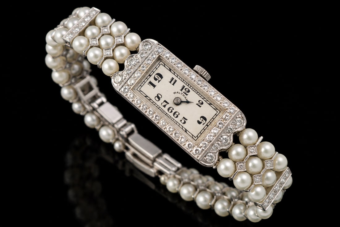 18k White Gold & Pearl Ladies Watch: vintage Waltham ladies’ wristwatch crafted in 18K white gold, accented with lustrous pearl bracel and powered by a manual-wind movement. Weight 24.9 Grams