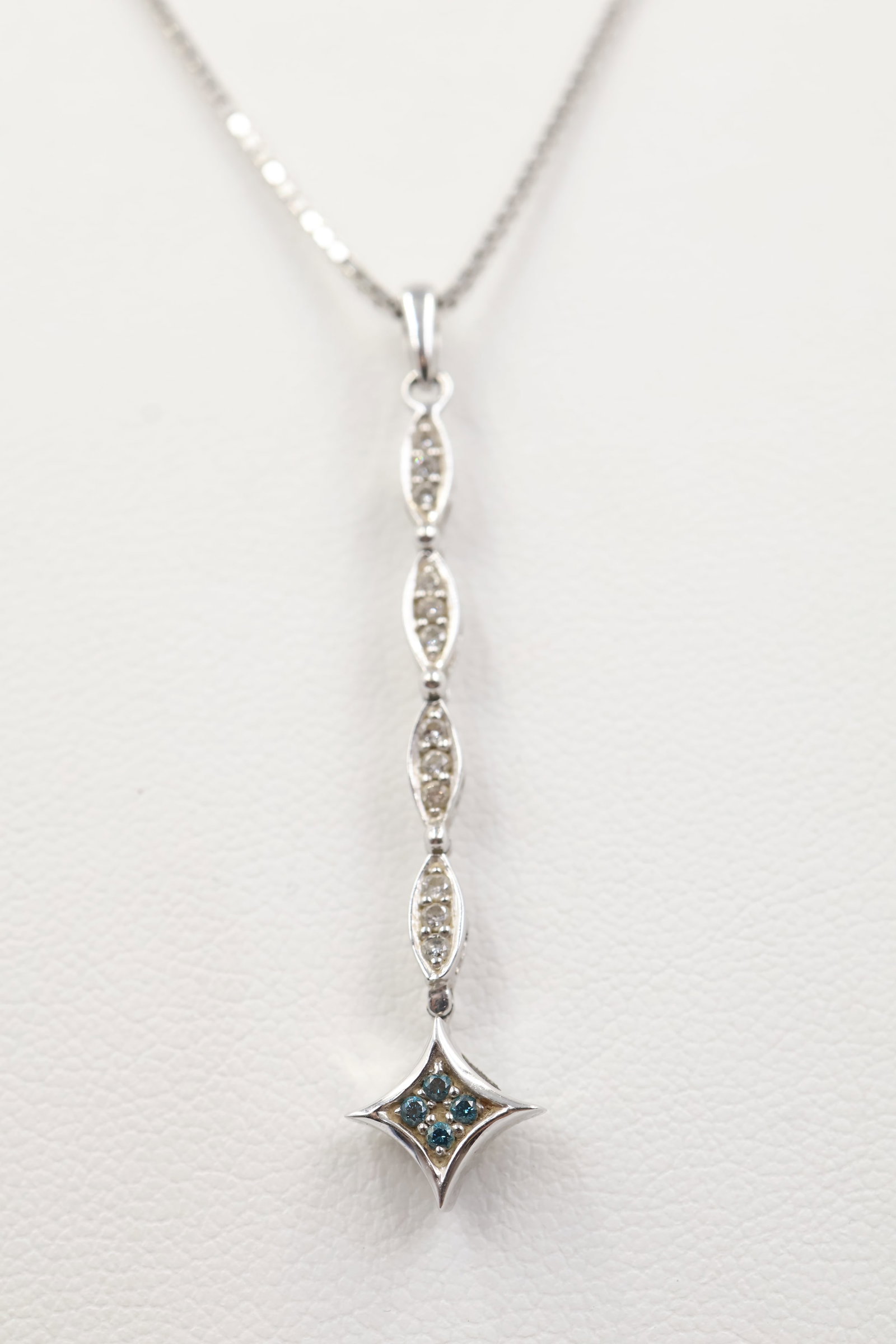 14k White Gold & Diamond Pendant: Elegant 14K white gold pendant featuring four round brilliant-cut diamonds, suspended from an 18-inch chain. Total weight: 5.9 grams.