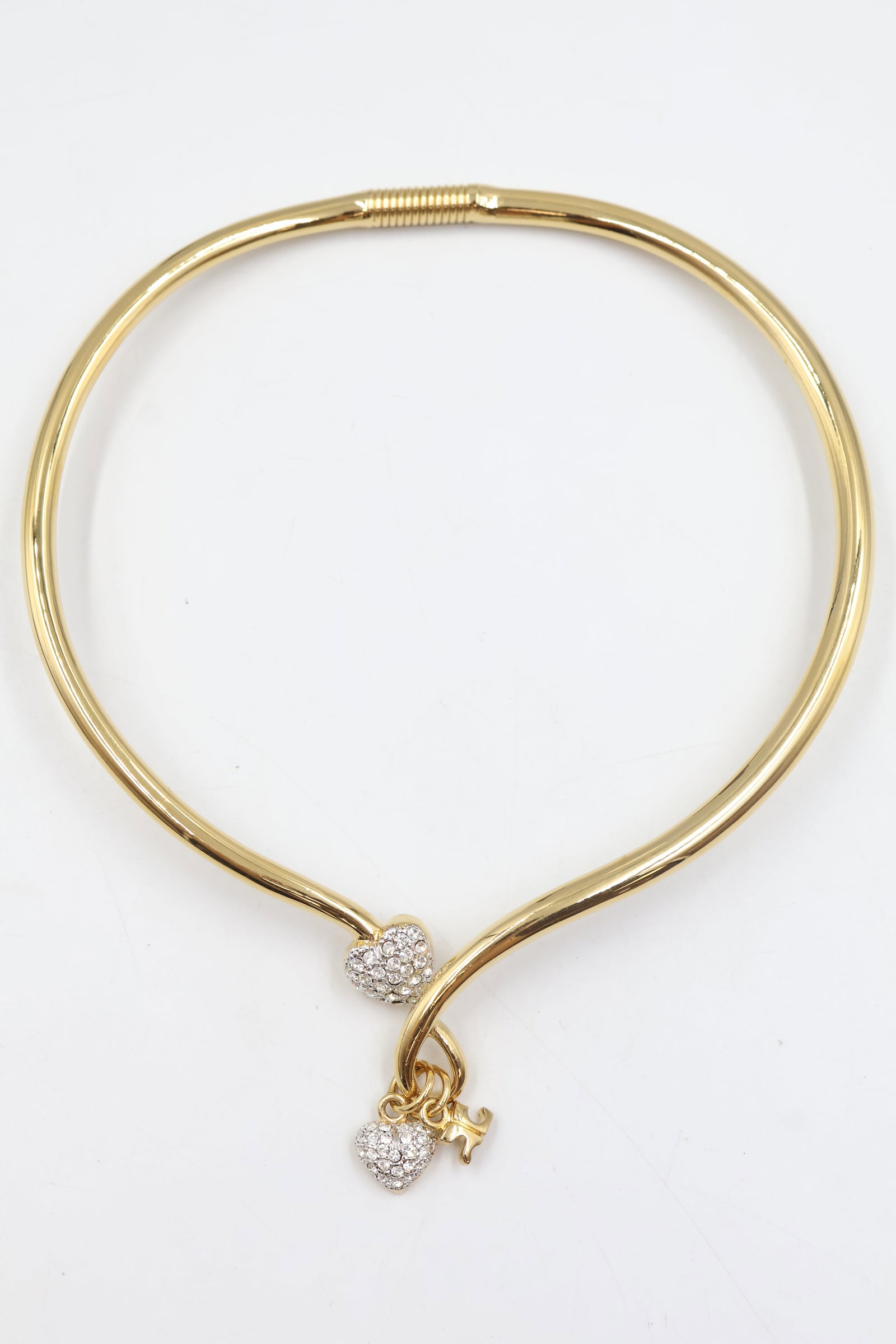 Courreges Paris Gold Tone Crystak Heart Choker: Courrèges Paris choker featuring a bold gold-tone heart motif. A distinctive statement piece showcasing the French fashion house’s modern and iconic design aesthetic.