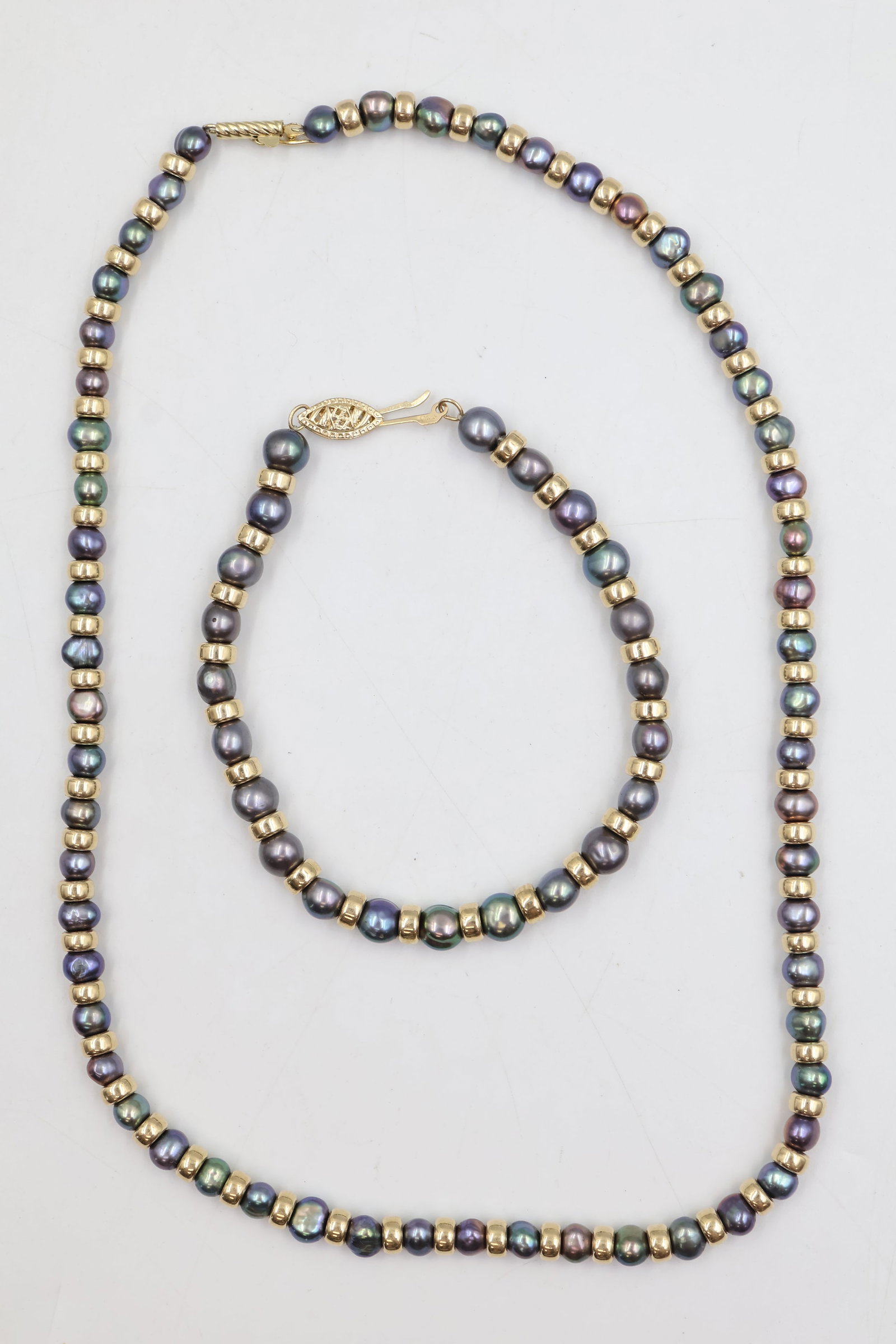 14k Gold & Pearl Necklace & Bracelet: Elegant matching necklace and bracelet set crafted in 14K gold and featuring lustrous pearls. A timeless and sophisticated ensemble showcasing classic elegance and refined craftsmanship. Weight 25.58