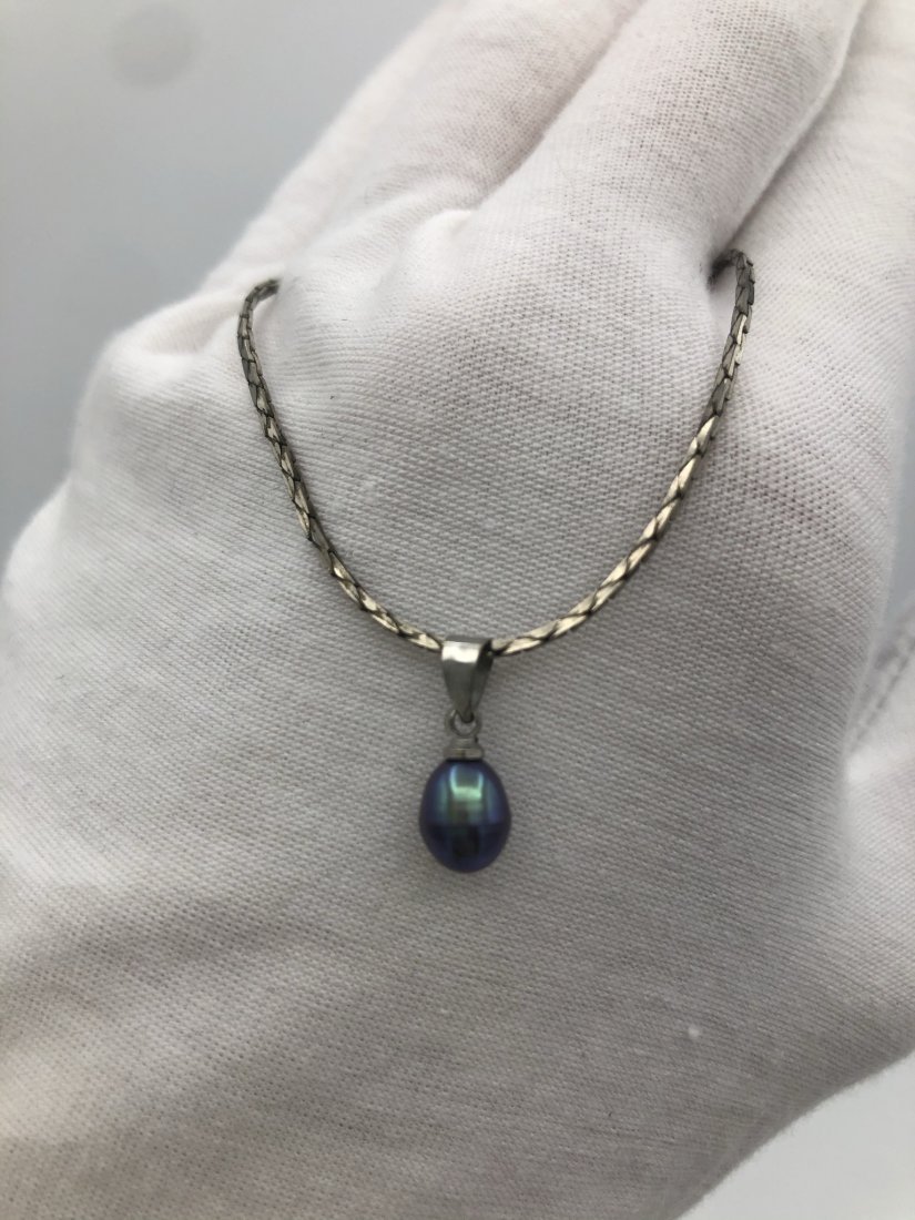 Natural South Sea Tahitian Black Pearl Drop Pendant in: One of the rarest pearls known to man, this natural beauty grows in the South Tahitian Sea. It has been crafted and set in solid 18K White Gold