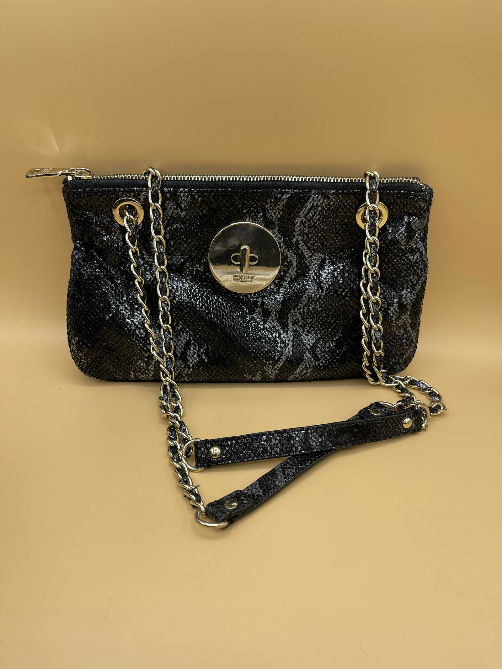 DKNY Snakeskin Lambskin Leather Chain Purse: New condition, no signs of wear, this DKNY small chain clutch purse has a twist lever opening that leads to a smooth velour inside finish