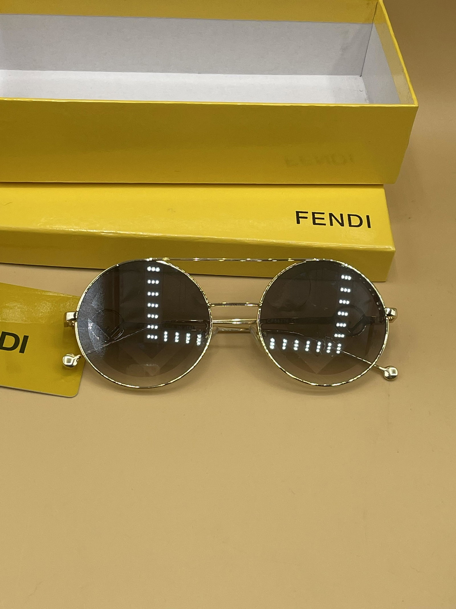 FENDI Gold Tone FF Monogram Lens Sunglasses: Limited Release FENDI Gold Tone FF Monogram Lens Sunglassesa, new, in original packaging including: original exterior box, singlasses case, polishing cloth, plastic authenticity card, and sunglasses