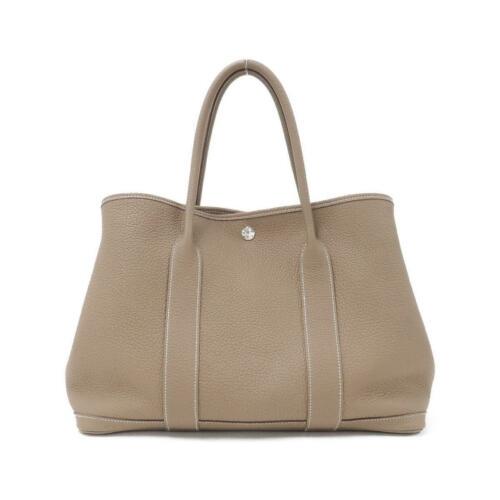Authentic HERMES Garden Party 36cm 051559CK: This item qualifies for FREE DOMESTIC SHIPPING to customers in the USA Brand: Hermes Size: W X H X Gusset (W) : 36Cm X 26Cm X 18Cm Handle:36Cm Style: Tote Bag Mpn: 051559Ck Color: Etoupe Silver Metal 