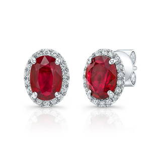 Ruby And Diamond Oval Halo Earrings In 14k White Gold: This item qualifies for FREE DOMESTIC SHIPPING to customers in the USA Classic Oval Halo Earring Features 7x5mm Ruby Framed By 0.17ctw Of Round Brilliant Diamonds In 14k White Gold 14k White Gold