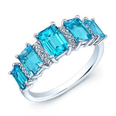 Swiss Blue Topaz 5 Stone & Diamond Emerald Cut Ring In 18k White: Swiss Blue Topaz 5 Stone & Diamond Emerald Cut Ring In 18k White This Elegant 5 Stone Emerald Cut Swiss Blue Topaz Ring Is Exquisitely Set In A 18k White Gold Setting Beautifully Highlighted By Sparkl