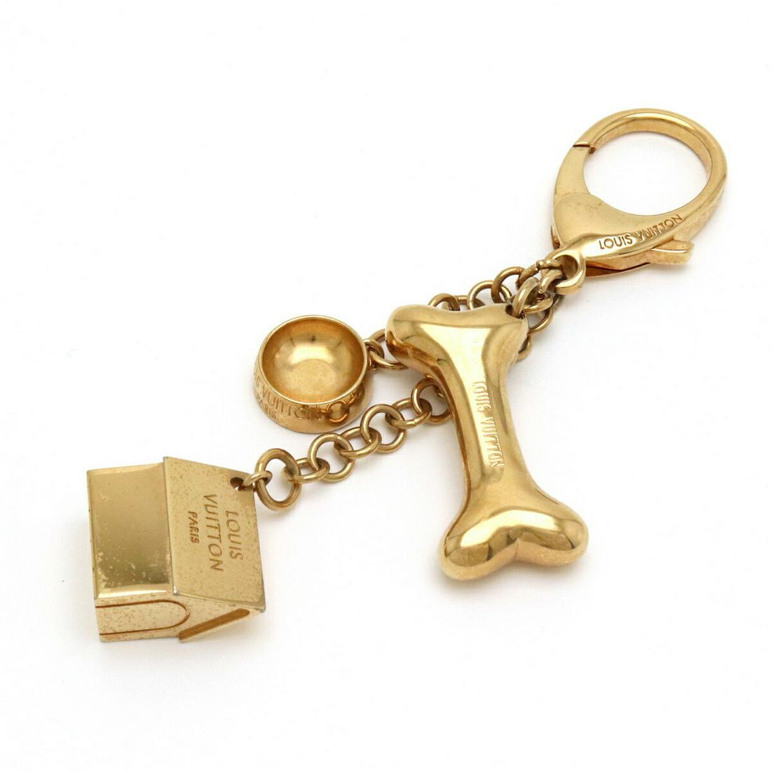 LOUIS VUITTON Louis Vuitton Bijoux Sack Baxter Keychain Key Ring Charm Bag Gold Color GP: LOUIS VUITTON Louis Vuitton Bijoux Sack Baxter Keychain Key Ring Charm Bag Gold Color GP Brand: Louis Vuitton Material: Gold plating Condition: Used (good) Overall Scratches: Moderate The Mynt Guarant