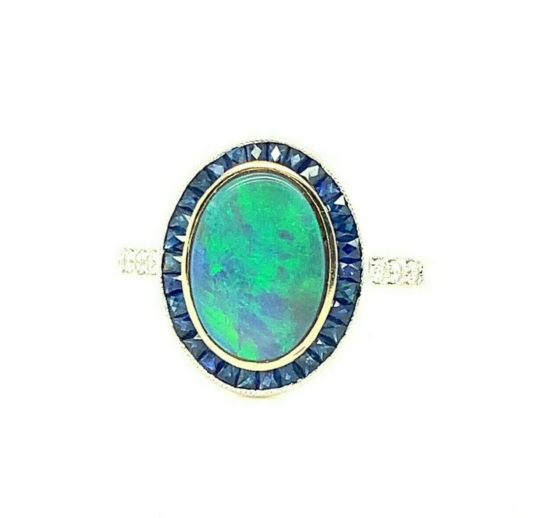18k Gold 1.07 Carat Genuine Natural Australian Black Opal and Sapphire: 18k Gold 1.07 Carat Genuine Natural Australian Black Opal and Sapphire Base Metal: White Gold Certification: GIA Material: Metal Type: Ring Secondary Stone: Sapphire Vintage: Yes Metal Purity: 18k