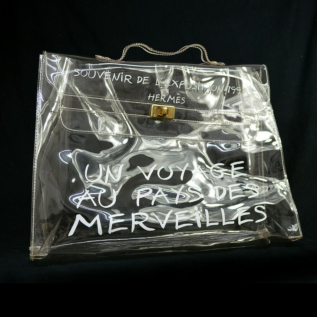 HERMES Vinyl Kelly Hand Beach Bag SOUVENIR DE L'EXPOSITION 1997: HERMES Vinyl Kelly Hand Beach Bag SOUVENIR DE L'EXPOSITION 1997 Exterior Color: Clear Strap Drop: 1.6 Exterior Material: Vinyl Bag Height: 11.4 Size: Medium Bag Width: 15.7 Bag Depth: 4.5 Brand: HERME