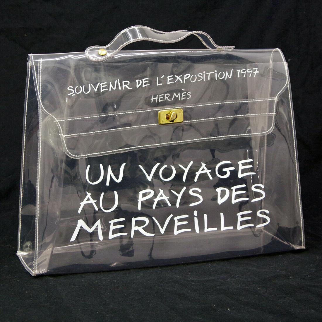 HERMES Vinyl Kelly Hand Beach Bag SOUVENIR DE L'EXPOSITION 1997: HERMES Vinyl Kelly Hand Beach Bag SOUVENIR DE L'EXPOSITION 1997 Exterior Color: Clear Strap Drop: 1.6 Exterior Material: Vinyl Bag Height: 11.4 Size: Medium Bag Width: 15.7 Bag Depth: 4.5 Brand: HERME